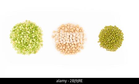 three kinds of raw dried legumes - chickpeas, mung bean, green peas, isolated on white background Stock Photo