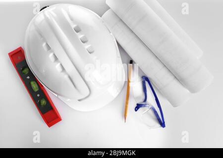 Construction drawings with tools and helmet, top view Stock Photo