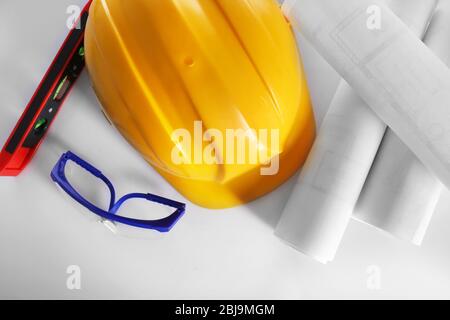Construction drawings with tools and helmet, top view Stock Photo