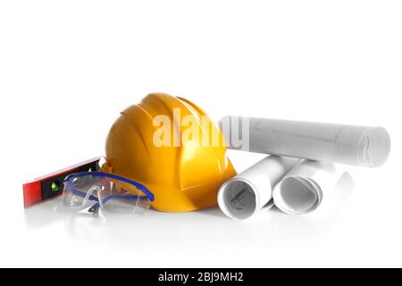 Construction drawings with tools and helmet isolated on white Stock Photo