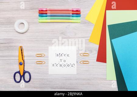 top view of material for making crafts on a wooden table and a paper with the message back to school, copy space for text, concept of art and leisure Stock Photo