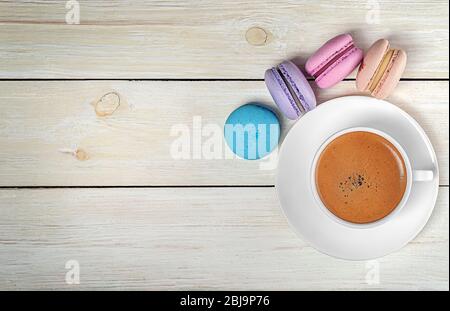 Macaroons and cup with coffee on top Stock Photo