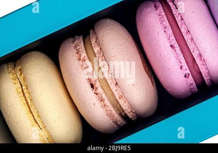 Three macaroons in box closeup Stock Photo