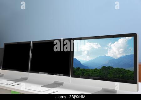 Row of computers in office Stock Photo