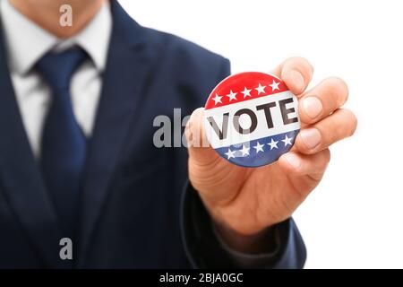 American votes concept. Man holding voting badge, close up Stock Photo