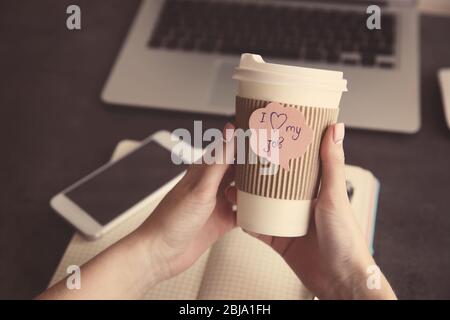 I love my job concept. Female hands holding hot cup of coffee Stock Photo