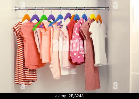 Children clothes on hangers in a room. wardrobe with boy's clothes on  hangers. Shopping and consumerism concept. Dressing closet with clothes  arranged Stock Photo - Alamy