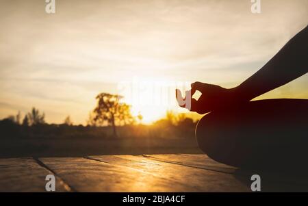 Young woman practicing yoga in the nature.Healthy and Yoga Concept.Copy space for banner. Stock Photo