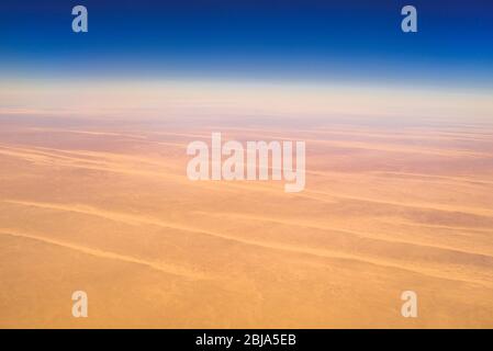Aerial airplane view of barren Sahara desert landscape in Egypt Stock Photo