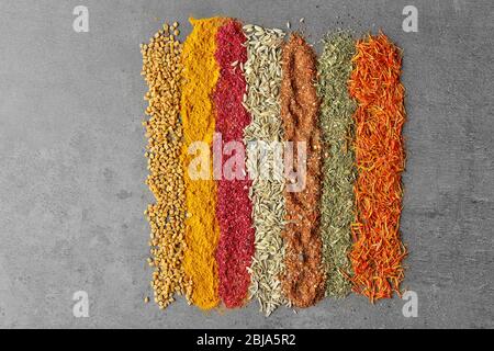 Different spices on gray background Stock Photo