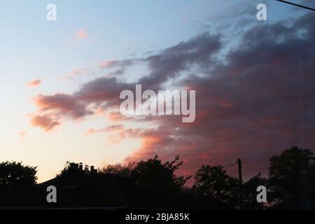 Dark pink cloudy sunset in Manchester, England Stock Photo