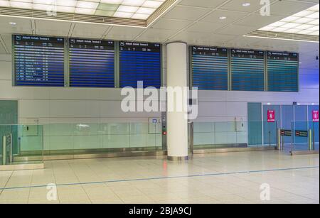 Munich, Germany - April 23th 2020: Empty and abandoned arrival area at Munich Airport Franz Josef Strauss during Corona pandemic. Stock Photo