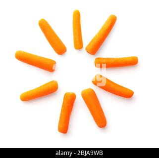 Small baby carrots in flower shape on white background Stock Photo