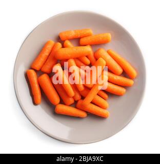 Small baby carrots in plate on white background Stock Photo