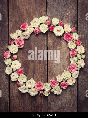 Assorted roses heads on wooden background Stock Photo - Alamy