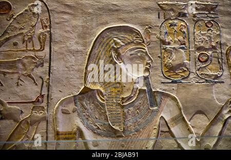 Ancient paintings and Egyptian hieroglyphs at the pharaoh tomb in the Valley of the Kings in Luxor, Egypt Stock Photo