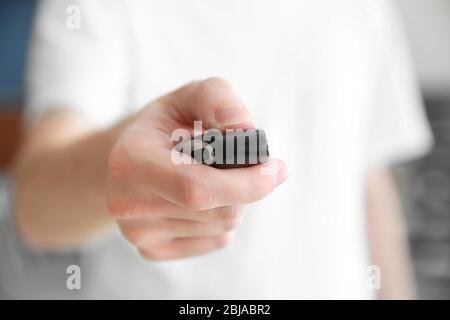 Man hand pressing remote control car alarm Stock Photo