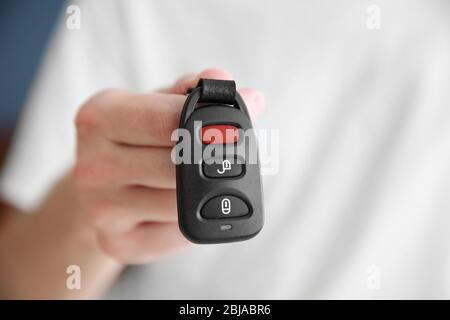 Man hand holding remote control car alarm Stock Photo