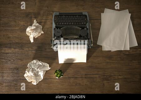 Retro typewriter with sheet of paper on wooden background Stock Photo