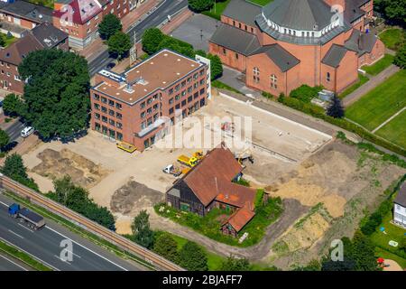 Catholic Parish of the Holy Cross in Gladbeck, in the foreground the new building of the family doctor center Butendorf at the Horster street, 19.07.2016, aerial view, Germany, North Rhine-Westphalia, Ruhr Area, Gladbeck Stock Photo