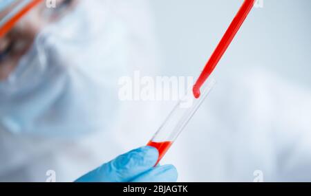 Analysis virus in China and world from coronavirus, doctor in protective chemical suit with respirator computer in laboratory Stock Photo