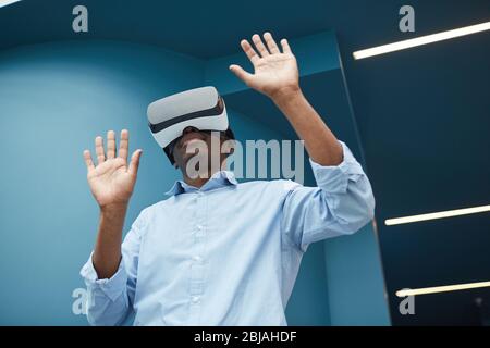 African businessman in VR glasses he is in virtual reality he standing and gesturing Stock Photo