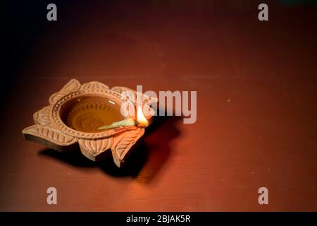 Diya lamps lit with bokeh background during diwali celebration Stock Photo