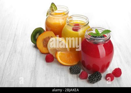 Fresh fruit and berry cocktails on wooden background Stock Photo