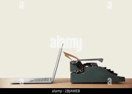 Old typewriter and laptop on table. Concept of technology progress Stock Photo