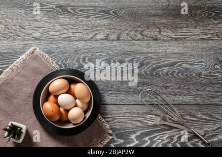 Fresh farmer market eggs on a kitchen table with utensils Stock Photo