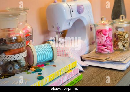 Sewing machine and materials in a study. Stock Photo