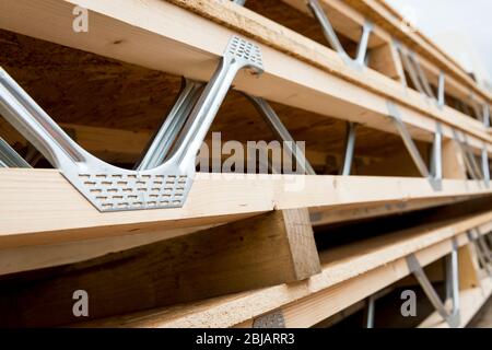 Wooden roof joists ready to be installed on a building site. Stock Photo