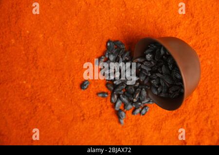 Dried barberry in bowl on paprika powder background Stock Photo