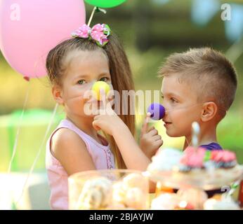 Children celebrating birthday in park Stock Photo