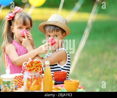 Children celebrating birthday in park Stock Photo