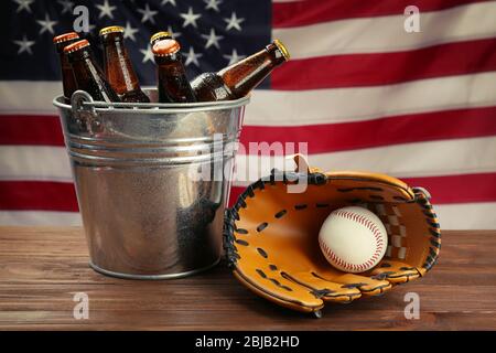 Baseball glove with ball and beer on wooden table Stock Photo