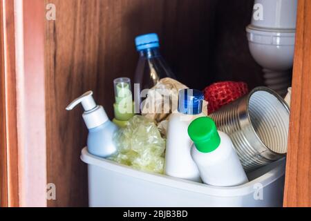 Plastic trash can in the kitchen cabinet - bottles, plastic and metal ...