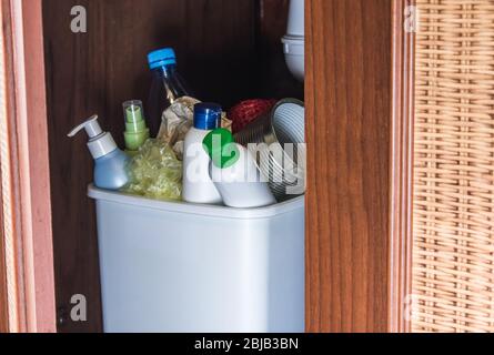 Plastic trash can in the kitchen cabinet - bottles, plastic and metal ...