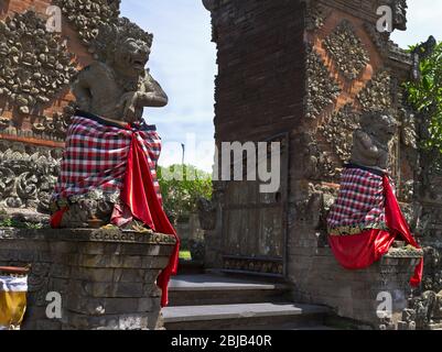 dh Balinese Batuan temple gods BALI INDONESIA Traditional Hindu gate guards statues guard entrance to guardians hinduism Stock Photo