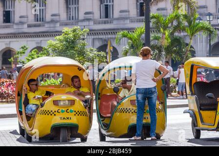 Old Havana, Cuba. Typical Coco Taxi parked at Parque Central waiting for tourists Stock Photo