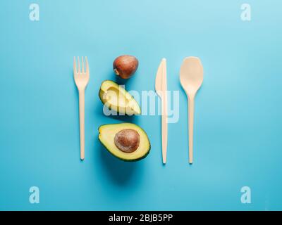 Avocado Seeds Biodegradable Single-Use Cutlery. Bioplastic - Great alternative to plastic disposable cutlery. Minimal concept on blue background. Stock Photo
