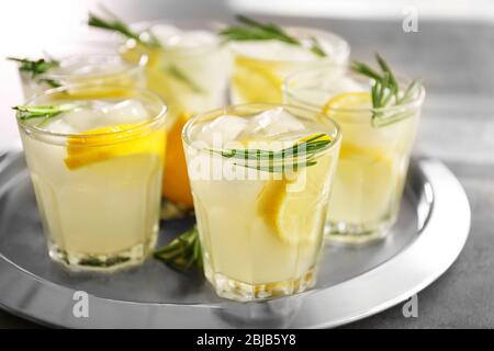 Cold fresh cocktail with lemon on metal tray Stock Photo
