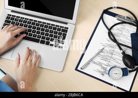 Female doctor hands typing on laptop Stock Photo