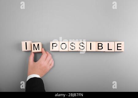Human hand turning word impossible into possible Stock Photo