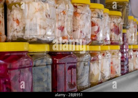 Traditional homemade pickles in plastic jar of various fruits and vegetables Stock Photo