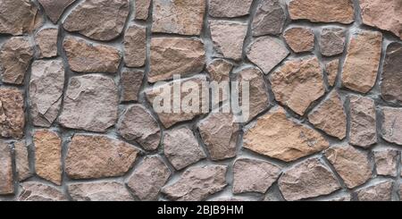Brown stone wall texture, floor background. Wide panoramic rock pattern. Natural masonry surface, brick frame. Grunge structure. Design element Stock Photo
