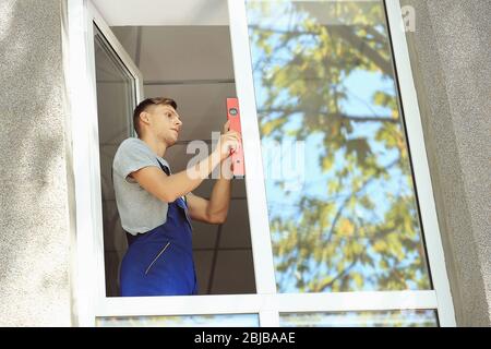 Construction worker installing window in house Stock Photo