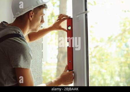 Construction worker installing window in house Stock Photo