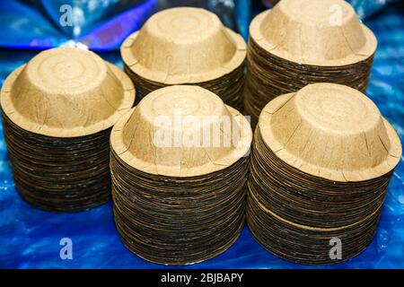Close up of eco friendly compostable paper bowls stack on the table,piles of paper bowls for momo dumplings. Selective Focus Stock Photo