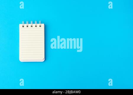 open blank notebook in line on a blue background, copy space Stock Photo